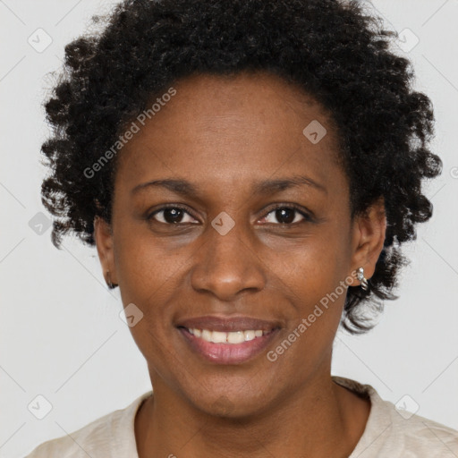 Joyful black adult female with short  brown hair and brown eyes