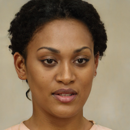 Joyful black young-adult female with short  brown hair and brown eyes