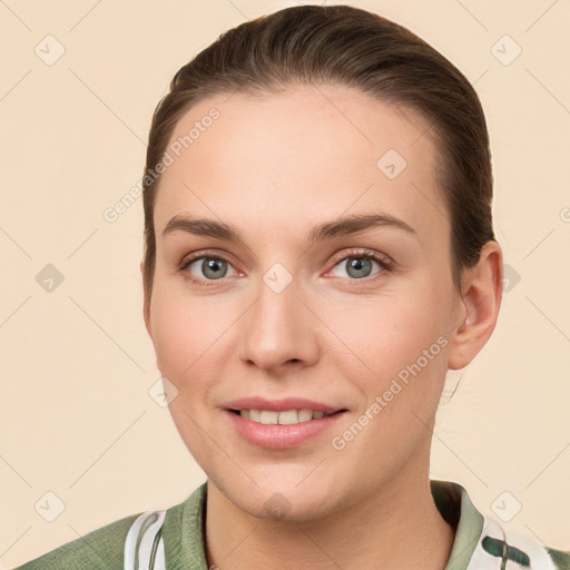 Joyful white young-adult female with short  brown hair and grey eyes