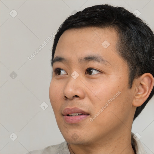 Joyful asian young-adult male with short  black hair and brown eyes