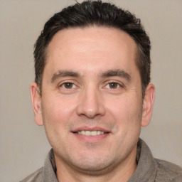 Joyful white adult male with short  brown hair and brown eyes
