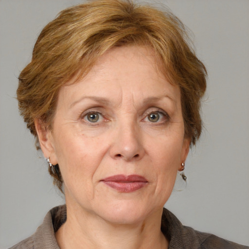 Joyful white middle-aged female with medium  brown hair and grey eyes