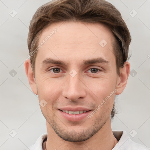 Joyful white young-adult male with short  brown hair and grey eyes