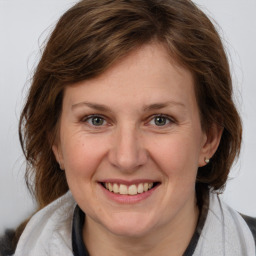 Joyful white adult female with medium  brown hair and brown eyes