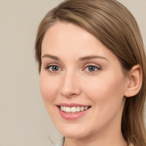 Joyful white young-adult female with long  brown hair and grey eyes