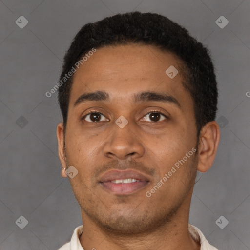 Joyful latino young-adult male with short  brown hair and brown eyes