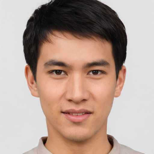 Joyful asian young-adult male with short  brown hair and brown eyes