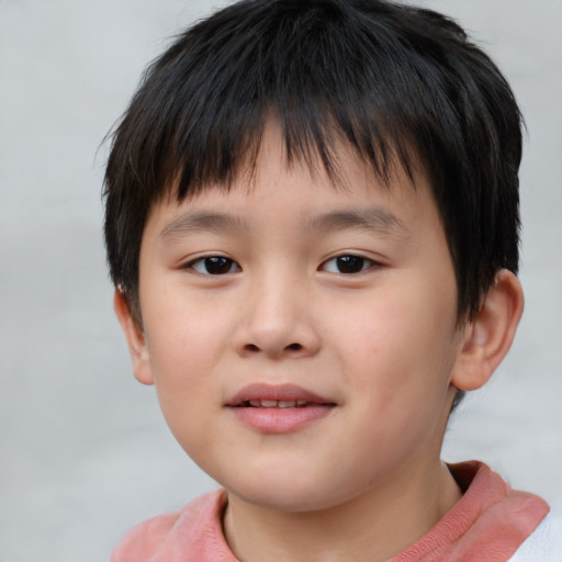 Joyful asian child male with short  brown hair and brown eyes