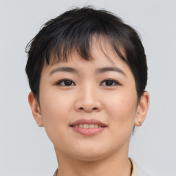 Joyful asian young-adult female with short  brown hair and brown eyes