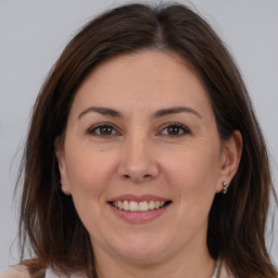 Joyful white adult female with medium  brown hair and brown eyes