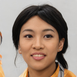 Joyful asian young-adult female with medium  black hair and brown eyes