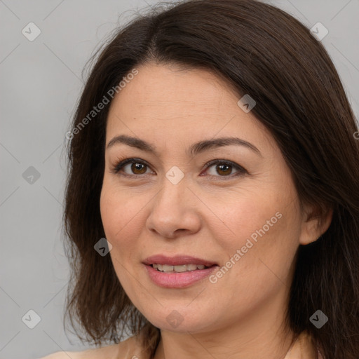 Joyful white adult female with medium  brown hair and brown eyes