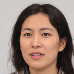 Joyful asian adult female with medium  brown hair and brown eyes