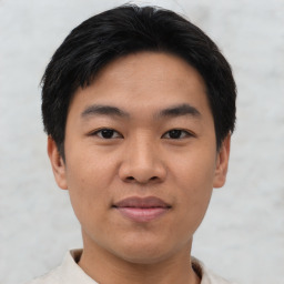 Joyful asian young-adult male with short  black hair and brown eyes