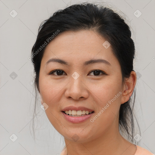 Joyful asian young-adult female with medium  brown hair and brown eyes