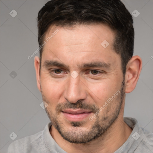 Joyful white adult male with short  brown hair and brown eyes