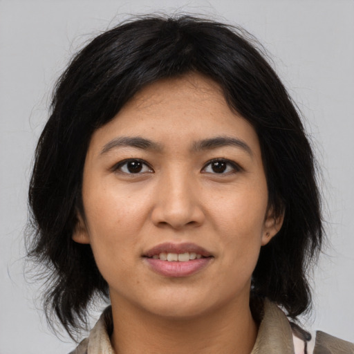 Joyful asian young-adult female with medium  black hair and brown eyes