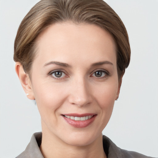 Joyful white young-adult female with short  brown hair and grey eyes