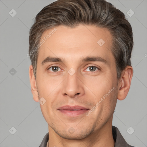 Joyful white adult male with short  brown hair and brown eyes