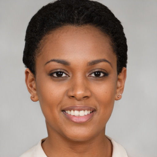 Joyful black young-adult female with short  brown hair and brown eyes