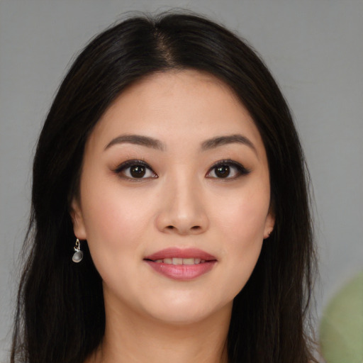 Joyful white young-adult female with long  black hair and brown eyes