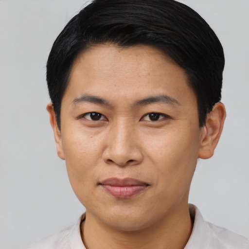 Joyful asian young-adult male with short  black hair and brown eyes