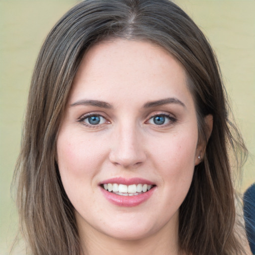 Joyful white young-adult female with long  brown hair and blue eyes