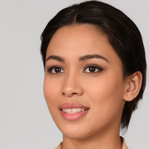 Joyful white young-adult female with medium  black hair and brown eyes