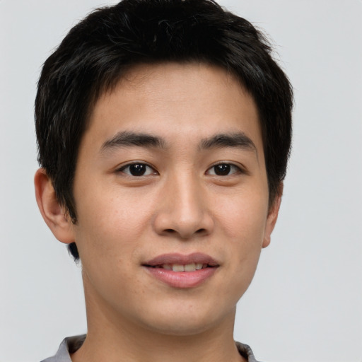 Joyful asian young-adult male with short  brown hair and brown eyes