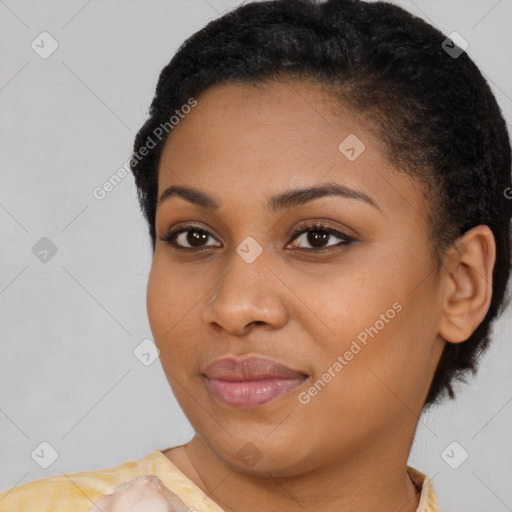 Joyful black young-adult female with short  black hair and brown eyes