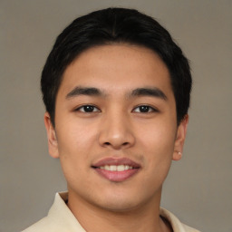 Joyful white young-adult male with short  black hair and brown eyes