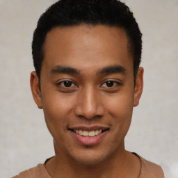 Joyful latino young-adult male with short  brown hair and brown eyes