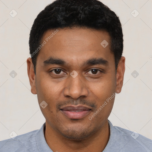 Joyful latino young-adult male with short  black hair and brown eyes