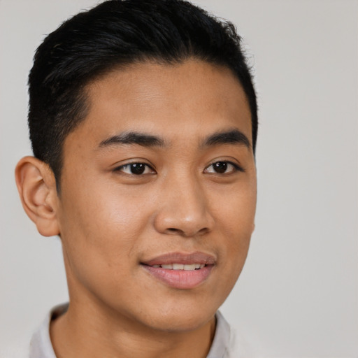 Joyful latino young-adult male with short  brown hair and brown eyes