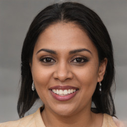 Joyful black young-adult female with medium  brown hair and brown eyes