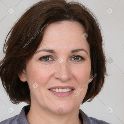 Joyful white adult female with medium  brown hair and grey eyes