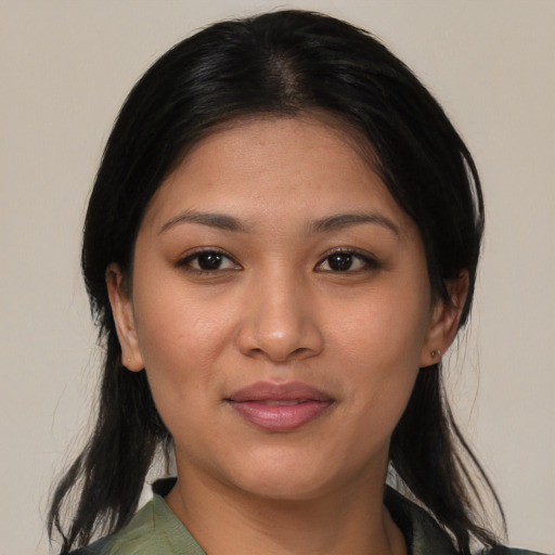 Joyful white young-adult female with medium  black hair and brown eyes