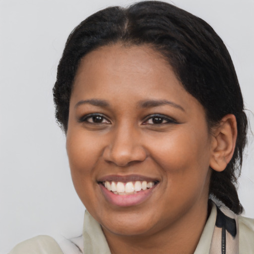 Joyful black young-adult female with medium  brown hair and brown eyes