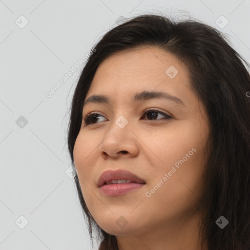 Joyful asian young-adult female with long  brown hair and brown eyes