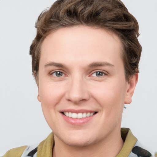 Joyful white young-adult female with short  brown hair and grey eyes