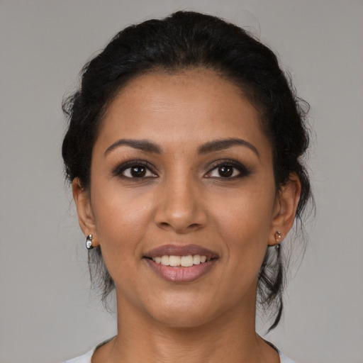 Joyful latino young-adult female with medium  black hair and brown eyes