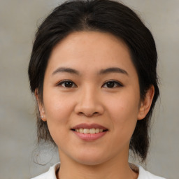 Joyful asian young-adult female with medium  brown hair and brown eyes