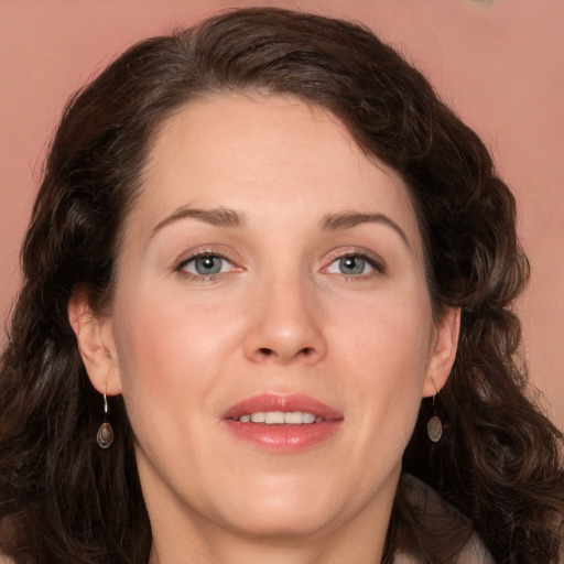 Joyful white young-adult female with long  brown hair and green eyes