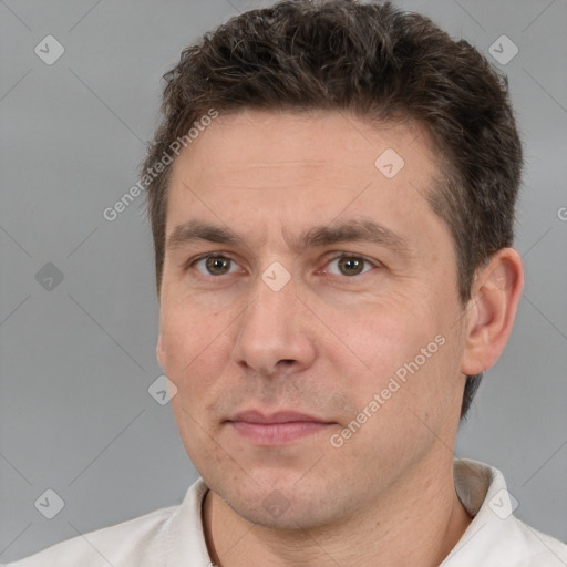 Joyful white adult male with short  brown hair and brown eyes