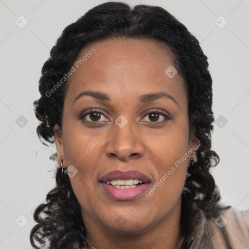 Joyful black adult female with long  brown hair and brown eyes