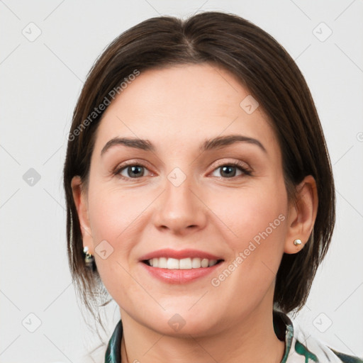 Joyful white young-adult female with medium  brown hair and grey eyes