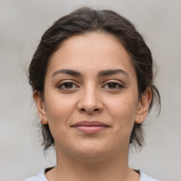 Joyful white young-adult female with medium  brown hair and brown eyes