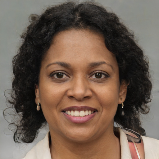 Joyful black young-adult female with medium  brown hair and brown eyes
