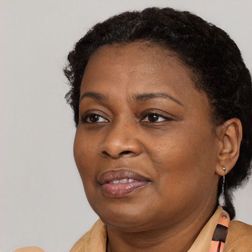 Joyful black adult female with short  brown hair and brown eyes
