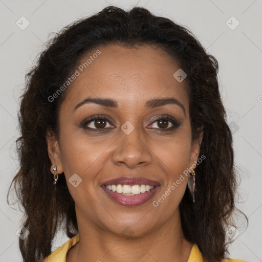 Joyful black young-adult female with long  brown hair and brown eyes